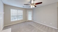 Located at 2101 21st St SE in Hickory, NC, this single-floor, 3-bedroom, 1-bathroom home offers a functional and comfortable layout. The living room serves as the heart of the home, featuring a classic tile-surround fireplace with a white mantel, plush carpet flooring, and a ceiling fan with light fixture. Natural light fills the space through large windows and a glass-paneled exterior door that opens to the outdoors. The kitchen is well-appointed with dark espresso cabinetry, light countertops, and a full suite of stainless steel appliances including a refrigerator, range, microwave, and dishwasher. Wood-look flooring and a peninsula counter connect the kitchen to the adjacent dining area. The three bedrooms are carpeted and finished in neutral tones, each offering a clean, move-in-ready feel. The primary bedroom includes access to a dedicated walk-in closet outfitted with multi-level wire shelving for ample storage. The bathroom features a full-size soaking tub with an overhead shower. A pendant light fixture highlights the dining area, and textured ceilings are consistent throughout the home, contributing to its cozy, residential character.