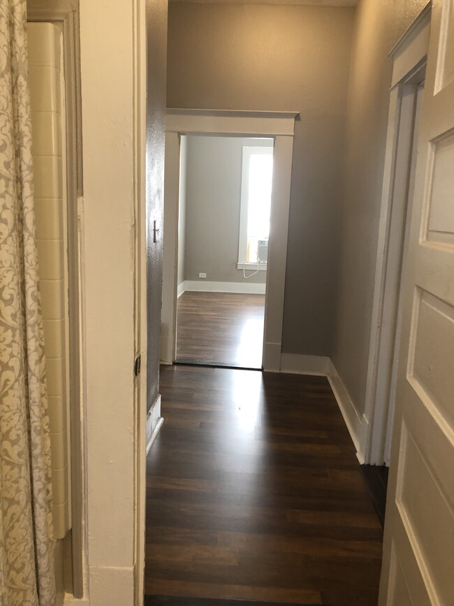 View of hallway overlooking the dining room as you walk out of the bathroom. - 215 Rigsby Ave