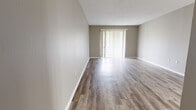 Located at 110 Pine Knoll Dr in Ridgeland, Mississippi, this single-floor, 2-bedroom, 1-bathroom residence offers a practical and comfortable layout across a well-utilized floor plan. The living room serves as the heart of the home, featuring warm hardwood-style flooring, neutral taupe walls, a textured ceiling, and a sliding glass door fitted with vertical blinds that fills the space with natural light and provides access to an outdoor area. Adjacent to the living room, the dining area offers the same hardwood-style flooring and connects seamlessly to the galley-style kitchen. The kitchen is well-appointed with crisp white cabinetry, white countertops, stainless steel appliances including a refrigerator, dishwasher, and electric range, and light wood-style flooring throughout. Both bedrooms are carpeted in a neutral gray tone and feature closets, providing a quiet and comfortable retreat. The primary bedroom is generously sized, offering ample space for furnishings. The bathroom includes a white vanity with a large mirror, updated hardware, and hardwood-style flooring. A hallway connects the private areas of the home, completing this efficiently designed, move-in-ready residence.