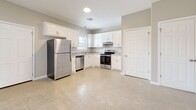 Located at 187 Venable Ln in Monroe, Louisiana, this single-story 2-bedroom, 2-bathroom home offers a clean, modern aesthetic throughout. The interior is unified by polished concrete floors that reflect natural light and lend a sleek, low-maintenance quality to the living spaces. The open living room is bright and airy, with neutral walls, recessed lighting, and clear sightlines to the bedrooms, creating a welcoming and functional flow. The kitchen is a standout feature, outfitted with white shaker-style cabinetry, granite-look countertops, and a full suite of stainless steel appliances including a refrigerator, dishwasher, and range. A window above the sink brings in natural light, enhancing the kitchen's clean, contemporary feel. The primary bedroom offers a comfortable footprint with neutral tones and access to a closet. The second bedroom also features polished concrete floors and a large window that fills the room with natural light, along with its own closet for added storage. Both bathrooms are finished with white cabinetry, granite-topped vanities, and lighted mirrors, maintaining a consistent and refined design language throughout the home. Neutral wall tones and consistent finishes give the entire space a cohesive, move-in-ready appearance.