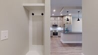 This 660 square foot apartment offers a well-designed living space with one bedroom and one bathroom. The interior showcases modern finishes, including sleek laminate flooring throughout, creating a cohesive and contemporary look. The living area is bathed in natural light, thanks to a large window and glass door leading to a balcony or patio, providing views of neighboring buildings.

The space features recessed lighting and neutral-toned walls, enhancing the bright and airy atmosphere. The layout is efficiently designed to maximize the available square footage, with the 130 square foot primary bedroom likely situated adjacent to the main living area. The apartment includes essential spaces such as a kitchen, living room, hallway, and a closet for storage.

While compact, the apartment's design focuses on functionality and comfort. The urban setting suggests convenient access to city amenities. This space would be ideal for singles or couples seeking a modern, low-maintenance home in a vibrant urban environment.