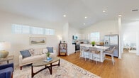 Located in Weatherford, TX, this thoughtfully designed single-story home offers two bedrooms and two bathrooms within a bright, open-concept floor plan. The combined kitchen and living area serves as the heart of the home, featuring vaulted ceilings that amplify the sense of space and an abundance of natural light streaming through plantation-shuttered windows. The kitchen is appointed with crisp white cabinetry, a subway tile backsplash, stainless steel appliances, and a central island with bar seating — ideal for both everyday meals and casual entertaining. Warm wood-look flooring flows seamlessly throughout the main living areas, adding a cohesive, inviting feel. The living room is generously proportioned, benefiting from elevated clerestory windows that bathe the space in natural light. The spacious primary bedroom features vaulted ceilings, a ceiling fan, and high-set windows for added privacy. The en suite bathroom is elegantly finished with a double vanity, LED-lit mirror, and a glass-enclosed walk-in shower clad in marble-style tile. The second bathroom offers a tub-shower combination with clean white tile. Hallways connect the rooms efficiently, and a dedicated closet provides practical storage. The overall aesthetic is clean, modern, and bright throughout.