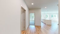 Located at 2152 Middleton Beach Rd in Middleton, WI, this well-appointed two-bedroom, two-bathroom single-floor home offers a clean, modern aesthetic with thoughtful finishes throughout. The open-concept kitchen and living area serves as the heart of the home, featuring light hardwood flooring, a large white island with pendant lighting, white cabinetry with a subway tile backsplash, and stainless steel appliances including a range, microwave, and refrigerator. Generous windows flood the space with natural light and frame views of the surrounding greenery. The living area extends the open feel with additional large windows and access to an outdoor area. Both bedrooms are carpeted and equipped with ceiling fans, offering comfort and garden views. The primary bedroom includes a spacious walk-in closet outfitted with built-in shelving and hanging rods for ample storage. The two bathrooms are finished with light wood-look vinyl flooring and brushed nickel fixtures; one features a walk-in shower while the other offers a full tub-shower combination. Clean white walls and neutral tones create a bright, cohesive ambiance throughout the entire home.