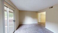 This single-floor, 2-bedroom, 1-bathroom residence in Gardendale, Alabama offers a practical and well-organized layout across a comfortable footprint. The living area is generously sized, featuring neutral-toned carpet, warm beige walls, and a sliding glass door that opens to a private balcony, allowing natural light to fill the space and providing pleasant outdoor views.

The galley-style kitchen is efficiently designed with warm wood cabinetry lining both walls, laminate countertops, and hardwood-style flooring. It comes equipped with a stainless steel refrigerator, electric range, and dishwasher, offering ample counter and storage space for everyday cooking needs.

The spacious primary bedroom includes closet access and connects conveniently to the hallway leading to the shared bathroom. The second bedroom is well-proportioned with carpeted flooring and a window that brings in natural light. Both bedrooms feature textured ceilings and neutral finishes throughout.

The bathroom is equipped with a full tub and shower combination with clean, white surround panels. Multiple hallways connect the various rooms, contributing to a logical and accessible flow throughout the unit. Overall, the space presents a clean, move-in ready environment with consistent finishes and a functional design suited for comfortable everyday living.