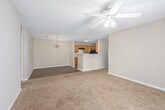Located at 2421 Chase Park Dr in Montgomery, Alabama, this single-story, 3-bedroom, 2-bathroom home offers a practical and comfortable layout. The kitchen features warm-toned wood cabinetry, a double stainless steel sink, light countertops, a black appliance suite including a refrigerator and range, and durable wood-look flooring. A peninsula counter connects the kitchen to the adjacent dining area, which is finished with the same wood-look flooring and accented by an elegant chandelier. The combined kitchen and dining space creates an open, functional hub for daily living. The bedrooms are carpeted throughout and bathed in natural light from windows that offer views of surrounding greenery. The primary bedroom provides a generous footprint with a closet, while the secondary bedrooms also include closet access and windows. Textured ceilings are consistent throughout the home. Both bathrooms are equipped with wood-look flooring, wood vanity cabinetry with countertops, and a tub-shower combination. Neutral wall tones in warm beige create a cohesive, understated palette throughout the home. The single-floor layout ensures ease of movement between the living, dining, kitchen, and sleeping areas, making this home a well-organized and accessible residence.
