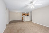 Located at 2421 Chase Park Dr in Montgomery, Alabama, this single-story, 3-bedroom, 2-bathroom home offers a practical and comfortable layout. The kitchen features warm-toned wood cabinetry, a double stainless steel sink, light countertops, a black appliance suite including a refrigerator and range, and durable wood-look flooring. A peninsula counter connects the kitchen to the adjacent dining area, which is finished with the same wood-look flooring and accented by an elegant chandelier. The combined kitchen and dining space creates an open, functional hub for daily living. The bedrooms are carpeted throughout and bathed in natural light from windows that offer views of surrounding greenery. The primary bedroom provides a generous footprint with a closet, while the secondary bedrooms also include closet access and windows. Textured ceilings are consistent throughout the home. Both bathrooms are equipped with wood-look flooring, wood vanity cabinetry with countertops, and a tub-shower combination. Neutral wall tones in warm beige create a cohesive, understated palette throughout the home. The single-floor layout ensures ease of movement between the living, dining, kitchen, and sleeping areas, making this home a well-organized and accessible residence.