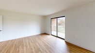 Located at 356 Ridge Rd in Dayton, NJ, this well-appointed 2-bedroom, 3-bathroom residence offers a thoughtfully designed single-floor layout with a clean, modern aesthetic throughout. Warm hardwood-style flooring flows continuously across every room, complemented by crisp white walls and classic white baseboards that give the entire space a bright, cohesive feel.

The kitchen stands out as a highlight, featuring striking granite countertops with bold veining, white shaker-style cabinetry with matte black hardware, stainless steel appliances including a refrigerator, electric range, and built-in microwave, as well as a stainless steel sink set into a generous kitchen island — ideal for both cooking and casual dining.

The living room is a comfortable, light-filled space with sliding glass doors that open directly onto a private balcony, offering pleasant outdoor views of the surrounding greenery. Both bedrooms are well-sized, each equipped with closets featuring built-in hanging rods, and windows that bring in natural light. The primary bedroom offers a notably generous footprint.

Three bathrooms serve the residence, including one full bath with a white-tiled tub-shower combination, wood-look flooring, and a clean vanity with a mirrored medicine cabinet. Two hallways connect the rooms efficiently, contributing to a practical and easy-to-navigate floor plan throughout.