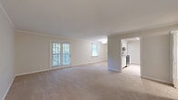 Located at 100 Watts Cir in Nashville, TN, this 2-bedroom, 2-bathroom single-floor home offers a well-organized layout with a clean, neutral aesthetic throughout. The open living room is generously sized, featuring soft carpet flooring, crown molding, and abundant natural light from multiple windows and a set of French doors that open to an outdoor area, providing a bright and welcoming atmosphere.

The galley-style kitchen flows directly off the living space and is outfitted with white shaker cabinetry, granite countertops, a subway tile backsplash, and light hardwood-style flooring. Stainless steel appliances, including a range and refrigerator, complete the functional cooking space.

Both bedrooms are carpeted and equipped with ceiling fans, offering comfortable and versatile spaces. The spacious primary bedroom includes a large window with natural greenery views, while the second bedroom also benefits from natural light through its own window. Two carpeted hallways connect the bedrooms to the rest of the home, lined with closet access doors for ample storage.

The bathrooms are finished with white cabinetry, granite-topped vanities, marble-look tile flooring, and clean white walls, giving them a bright and polished appearance. Overall, the home presents a cohesive, move-in-ready interior with consistent finishes throughout.