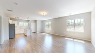 Located at 731 Federal Rd in Brookfield, CT, this well-appointed single-floor residence offers a clean, modern design with a thoughtful layout. Light wood-tone flooring runs consistently throughout, complemented by neutral gray walls and crisp white trim, creating a bright and cohesive aesthetic.

The open-concept kitchen and living area forms the heart of the home. The kitchen is outfitted with white shaker-style cabinetry, subway tile backsplash, stone countertops, and a full suite of stainless steel appliances, including a gas range, microwave, dishwasher, and refrigerator. A central island provides additional prep and dining space, while pendant lighting and a track light fixture add warmth. Multiple windows bathe the adjoining living area in natural light, with views of surrounding greenery.

The generously sized primary bedroom offers a serene retreat, featuring two windows that frame outdoor tree views and provide ample natural light. The room connects conveniently to the hallway, which leads to the full bathroom. The bathroom is appointed with a dark-stained vanity, white countertop, a large mirror with overhead lighting, and a full tub-shower combination.

The entrance and hallway provide a functional transition through the home, completing a practical and comfortable floor plan ideal for everyday living.
