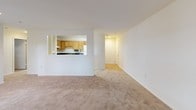 This single-floor residence offers a clean, functional layout designed for comfortable everyday living. The main living area is generously proportioned, featuring neutral wall-to-wall carpeting, crisp white walls, and recessed lighting that keeps the space feeling bright and airy. Vertical blinds on a large sliding door allow for adjustable natural light, adding versatility to the room's ambiance. The open layout flows seamlessly toward additional rooms, creating a connected and easy-to-navigate floor plan.

The kitchen is a practical and well-appointed space, featuring warm honey-toned oak cabinetry that extends to the ceiling for ample storage. Dark speckled countertops provide durable workspace, while the white electric range and stainless steel sink add a classic, functional aesthetic. The tile flooring in the kitchen offers easy maintenance, contrasting neatly with the carpeted living areas.

The bedrooms are comfortably sized, each with soft carpet underfoot and windows fitted with horizontal blinds that welcome natural light while maintaining privacy. Neutral tones throughout the rooms create a calm, versatile backdrop. The overall design of this residence emphasizes practicality and comfort, with a cohesive, understated palette that makes each space feel welcoming and move-in ready.
