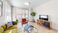 This contemporary apartment, located at 2 Lamartine St in Boston, MA, offers 740 square feet of efficiently designed living space. The single-story layout comprises two bedrooms, one bathroom, a living room, kitchen, and two hallways. The primary bedroom, measuring 130 square feet, provides a comfortable retreat.

The living area showcases a modern aesthetic with light-toned wood flooring and crisp white walls. Large windows allow natural light to flood the space, enhancing the open and airy ambiance. The living room features a stylish green sectional sofa, complemented by a glass coffee table and vibrant accent chairs, creating an inviting gathering space.

The kitchen boasts sleek white cabinetry, granite countertops, and stainless steel appliances, offering both functionality and visual appeal. The bathroom continues the modern theme with a clean, white color palette and contemporary fixtures.

Both bedrooms are thoughtfully designed with ample space for queen-sized beds and additional furniture. Colorful accents in the form of pillows and artwork add personality to the neutral base palette.

Throughout the apartment, strategically placed lighting fixtures and carefully curated artwork contribute to the overall modern and sophisticated atmosphere. The property's layout maximizes space efficiency while maintaining a sense of openness and flow between rooms.