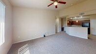 This 700 square foot apartment in Las Vegas offers a thoughtful layout maximizing space and functionality. The heart of the home is an open-concept living area seamlessly connecting to a modern kitchen. The kitchen boasts sleek cherry wood cabinetry, black appliances, and a convenient breakfast bar, ideal for casual dining or entertaining.

The living room features plush carpeting, a ceiling fan for comfort, and large windows allowing natural light to flood the space. The bedroom, measuring 140 square feet, provides a cozy retreat with ample room for a queen-sized bed and additional furniture. It also benefits from natural light and a ceiling fan.

The bathroom is well-appointed with a single vanity, large mirror, and a shower/tub combination. Tile flooring in the kitchen and bathroom adds a touch of elegance and practicality. Throughout the apartment, neutral wall colors create a blank canvas for personalization.

Storage is addressed with a dedicated closet space, while the overall design emphasizes an airy, open feel despite the compact square footage. This apartment represents an efficient use of space, perfect for those seeking a modern, low-maintenance lifestyle in the heart of Las Vegas.