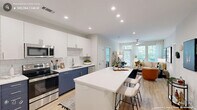 Located in Cary, NC, this thoughtfully designed 2-bedroom, 3-bathroom residence offers a modern open-concept layout that seamlessly connects the kitchen, dining, and living areas. The kitchen is a standout feature, showcasing a striking two-tone design with navy lower cabinets and crisp white upper cabinetry, complemented by a white quartz island with bar seating, subway tile backsplash, and stainless steel appliances. Light wood-tone flooring runs throughout the main living areas, enhancing the bright, airy atmosphere. The living room is anchored by large windows that frame views of lush greenery and provide generous natural light, with a ceiling fan adding to the comfort of the space. Both bedrooms are carpeted and generously sized, each featuring large windows with serene outdoor views, offering a calm retreat. The spacious primary bedroom provides ample room for a full furniture arrangement. The three bathrooms are finished with navy vanity cabinetry, white countertops, wood-look flooring, and subway tile shower surrounds — one featuring a glass-enclosed shower and another with a full soaking tub. Two closets provide convenient storage, rounding out this well-planned, contemporary residence.