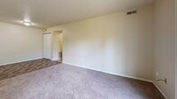 Located at 1710 Vale Park Road in Valparaiso, Indiana, this 2-bedroom, 1-bathroom residence offers a well-organized, single-floor layout designed for comfortable everyday living. The open-concept living and dining area is generously sized, featuring neutral-toned carpet, soft cream walls, and flush-mount lighting that create a bright, welcoming atmosphere. A peninsula with a dark granite-style countertop separates this space from the kitchen, providing a natural transition between the living and cooking areas.

The galley-style kitchen is well-appointed with rich dark wood cabinetry, stone-look countertops, black appliances including a refrigerator, electric range, and dishwasher, and durable tile flooring. A double basin sink and ample cabinet storage on both sides of the corridor make this kitchen both functional and visually cohesive.

The primary bedroom is a comfortable, carpeted retreat with a window overlooking mature greenery, a dedicated walk-in closet, and direct access to the full bathroom. The second bedroom is equally well-sized with carpet flooring and its own closet. The shared bathroom features a dark wood vanity, tile flooring, and a tub-shower combination. Additional highlights include in-unit laundry, a private balcony, and five total closets providing exceptional storage throughout.