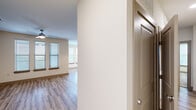 This thoughtfully designed 3-bedroom, 2-bathroom residence offers a comfortable and functional single-floor layout. The open-concept kitchen and living area serves as the heart of the home, featuring dark espresso cabinetry, granite countertops, stainless steel appliances, a central island with pendant lighting, and a subway tile backsplash — all complemented by light wood-style flooring that flows throughout the main living spaces. The living room benefits from an abundance of natural light through multiple windows fitted with blinds and is finished with a ceiling fan for added comfort. The bedrooms offer a mix of flooring, with carpeted rooms that include generous windows, providing a warm and relaxed atmosphere. The primary bathroom is well-appointed with dark cabinetry, granite vanity counters, a glass-enclosed walk-in shower, and wood-look tile flooring. The second bathroom features a full soaking tub with large-format tile surround. A dedicated in-unit laundry room houses a full-size washer and dryer with built-in shelving. The residence also includes a hallway, a closet for storage, and access to a private balcony, rounding out a practical and modern living environment.