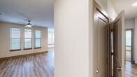 This thoughtfully designed 3-bedroom, 2-bathroom residence offers a comfortable and functional single-floor layout. The open-concept kitchen and living area serves as the heart of the home, featuring dark espresso cabinetry, granite countertops, stainless steel appliances, a central island with pendant lighting, and a subway tile backsplash — all complemented by light wood-style flooring that flows throughout the main living spaces. The living room benefits from an abundance of natural light through multiple windows fitted with blinds and is finished with a ceiling fan for added comfort. The bedrooms offer a mix of flooring, with carpeted rooms that include generous windows, providing a warm and relaxed atmosphere. The primary bathroom is well-appointed with dark cabinetry, granite vanity counters, a glass-enclosed walk-in shower, and wood-look tile flooring. The second bathroom features a full soaking tub with large-format tile surround. A dedicated in-unit laundry room houses a full-size washer and dryer with built-in shelving. The residence also includes a hallway, a closet for storage, and access to a private balcony, rounding out a practical and modern living environment.
