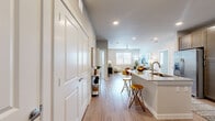This thoughtfully designed 2-bedroom, 2-bathroom residence features an open-concept floor plan that seamlessly connects the kitchen, dining area, and living room. Light wood-style flooring flows throughout the entire space, complementing the neutral color palette and creating a cohesive, modern aesthetic.

The kitchen is a standout feature, outfitted with rich dark wood cabinetry, granite countertops, a classic subway tile backsplash, and a full suite of stainless steel appliances. A peninsula with seating provides additional prep space and serves as a natural transition into the dining and living areas. Recessed lighting and a ceiling fan keep the space bright and comfortable.

Both bedrooms are generously sized with large windows that invite natural light and offer outdoor views. The primary bedroom includes a spacious walk-in closet equipped with multi-level wire shelving for ample storage. A second closet provides additional organization options.

The primary bathroom features a dual-sink vanity with granite countertops, dark wood cabinetry, and a full soaking tub with subway tile surround. The second bathroom mirrors the same quality finishes. Both bathrooms continue the wood-style flooring found throughout the residence, tying the design together for a clean, unified look.