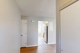 This single-floor, 2-bedroom, 1-bathroom unit offers a practical and efficient layout designed to maximize livability. The entrance leads into an open living and dining area finished with warm wood-tone laminate flooring, neutral gray walls, and a textured ceiling that carries consistently throughout the common areas. The space flows seamlessly into the kitchen, which features warm honey-toned wood cabinetry, granite-look countertops, stainless steel appliances including a full-size refrigerator and dishwasher, and tile flooring. A window above the counter brings in natural light and outdoor views.

Both bedrooms are carpeted and finished with the same neutral palette, offering a quiet and comfortable retreat. The primary bedroom provides a generous footprint, while the second bedroom also includes a window with natural light and outdoor views. Each bedroom benefits from access to the unit's five closets, offering exceptional storage throughout.

The full bathroom includes a tub-shower combination, a wood-vanity with sink, tile flooring, and a louvered closet door for additional storage. A dedicated laundry area adds everyday convenience. The hallway connects all spaces efficiently, completing this thoughtfully arranged, move-in-ready home.