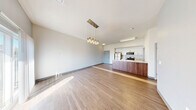 Located at 430 E Elm St in Springfield, MO, this modern 2-bedroom, 2-bathroom unit offers a thoughtfully designed open-concept layout across a single floor. The combined living and dining area is anchored by warm hardwood-style flooring and bathed in natural light from a sliding glass door that opens to a private balcony, offering open views of the surrounding Springfield cityscape and treetops.

The kitchen is a standout feature, equipped with stainless steel appliances including a refrigerator, range, and microwave, complemented by crisp white cabinetry and a generous granite-topped island with an integrated sink — ideal for both meal prep and casual dining. The kitchen flows seamlessly into the living area, making the space feel open and connected. An elegant pendant light fixture adds a modern decorative touch above the dining zone.

Both bedrooms are carpeted for comfort and benefit from natural light through well-placed windows. The primary bedroom includes access to a closet and offers a quiet, private retreat. Two full bathrooms serve the unit, one featuring a tub/shower combination with clean white surround.

Additional conveniences include a dedicated laundry area, utility room, hallway, and two closets, rounding out a well-organized and functional floor plan suited to everyday living.
