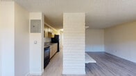 Located at 11102 E 16th Ave in Aurora, Colorado, this one-bedroom, one-bathroom unit offers a well-organized single-floor layout. The living room serves as the heart of the space, highlighted by a striking white-painted brick fireplace with an arched opening — a clear focal point that adds character to the room. Light wood-style laminate flooring runs throughout, complemented by neutral cream-toned walls and textured ceilings. Natural light filters in through windows flanking the entry door, and a wall-unit air conditioner and baseboard heating provide year-round climate control.

The kitchen is efficiently designed, featuring light wood cabinetry, granite-look countertops, a stainless steel sink, and black appliances including an electric range and over-the-range microwave. The bedroom offers a comfortable, quiet retreat with a double sliding-door closet, a window with outdoor views of surrounding greenery, and the same light flooring found throughout the unit. The bathroom includes a full soaking tub and shower combination, with a frosted window above providing natural light while maintaining privacy. This unit offers a practical and comfortable layout ideal for those seeking a streamlined living space in the Aurora area.