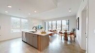 Located at 310 Del Sol Dr in San Diego's Mission Valley neighborhood, this contemporary single-floor residence showcases a thoughtfully designed open-concept layout with clean lines and modern finishes throughout. Polished concrete floors flow seamlessly across the main living areas, lending an urban, sophisticated character to the space.

The kitchen is a standout feature, equipped with stainless steel appliances, a gas range, a mosaic tile backsplash, and flat-front cabinetry in warm wood and muted gray tones. A generously sized island with a quartz countertop and an undermount sink offers both additional prep space and casual seating. The adjoining living and dining areas are bathed in natural light through floor-to-ceiling windows and sliding glass panels that frame views of palm trees and the surrounding San Diego landscape.

The bedrooms are bright and well-appointed, each featuring large windows with outdoor views. One bedroom is highlighted by a bold teal arched accent wall, while another features an artistic gold-toned wall mural, adding personality to the space. The bathrooms are finished with backlit vanity mirrors, quartz countertops, and contemporary cabinetry — one featuring a dual-sink vanity for added convenience. The overall ambiance of the residence is modern, airy, and vibrant.