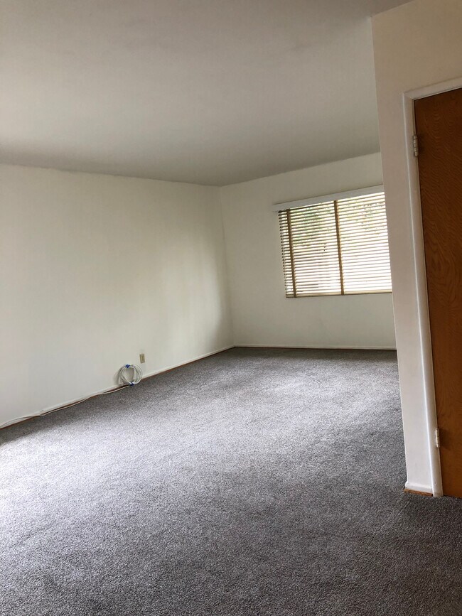 Enter the front door to a large living room area. - 7624 Norton Ave