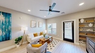 This thoughtfully designed single-story residence offers a cohesive open layout with light wood-style flooring and a neutral color palette that flows seamlessly throughout. The living room is bright and welcoming, featuring recessed lighting, a ceiling fan, and multiple windows that invite natural light, including a glass-panel exterior door that opens to the outside. A built-in shelving unit adds both style and function to the space. The adjacent dining area is an intimate nook, comfortably accommodating a small table and chairs beneath warm, understated décor. The galley-style kitchen is efficiently laid out with granite countertops, white upper cabinetry, and a full suite of stainless steel appliances, including a side-by-side refrigerator, range, and dishwasher. The bedroom is a comfortable retreat with its own ceiling fan, a natural light-filled window with outdoor views, and direct access to both the bathroom and a generously sized walk-in closet. The walk-in closet features extensive built-in shelving and dual hanging rods, maximizing storage capacity. The bathroom is finished with tile-surround walls, a sleek sliding glass shower enclosure, granite vanity, and modern fixtures, creating a clean and polished feel throughout.