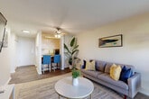 Located in Edmonds, WA, this well-appointed one-bedroom, one-bathroom unit offers a smart and efficient layout across a single floor. The open-concept living and dining area is bright and welcoming, featuring wood-style flooring, neutral tones, and a ceiling fan. A sliding glass door floods the space with natural light and opens to a private patio overlooking a green outdoor area, creating a seamless indoor-outdoor connection.

The galley-style kitchen is efficiently designed with warm honey-toned cabinetry, granite-look countertops, black appliances including a range and refrigerator, and a stainless steel sink — offering ample storage and prep space. A breakfast bar with seating connects the kitchen to the living area, making it ideal for casual dining.

The bedroom is a comfortable retreat with plush carpet, a well-sized closet, and a window that invites natural light. The full bathroom features a tub-shower combination, wood-style flooring, a vanity with stone-look countertops, and warm wood cabinetry.

A welcoming entry hallway with wood-style flooring ties the layout together, providing a smooth flow between all rooms. This unit combines practical functionality with a clean, modern aesthetic throughout.