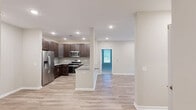 Located at 1514 Omaha Ct in Hamilton, NJ, this well-appointed 2-bedroom, 2-bathroom single-floor home offers a thoughtfully designed open-concept layout. The kitchen and living area flow seamlessly together, anchored by a stunning kitchen featuring rich dark-wood cabinetry, granite countertops, a center island with an undermount sink, and a full suite of stainless steel appliances including a gas range, microwave, and refrigerator with ice maker. Recessed lighting throughout enhances the bright, airy atmosphere. The living room is finished with light hardwood-style flooring and opens directly to a private balcony through a sliding glass door, bringing in abundant natural light and outdoor views. Both bedrooms are carpeted and well-lit with natural light from multiple windows. The spacious primary bedroom includes a dedicated walk-in closet with built-in wire shelving. The primary bathroom is elegantly finished with marble-style tile flooring, dark wood cabinetry, granite countertops, and a glass-enclosed walk-in shower. The second bathroom features classic white subway tile surrounding a full soaking tub and shower combination. A dedicated closet provides additional storage throughout this clean, modern home.