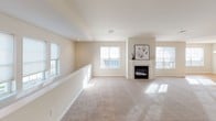 Located at 3362 Jacksonville Road in Bethlehem, PA, this single-floor residence offers a well-organized layout designed for comfortable everyday living. The kitchen is a functional centerpiece, featuring crisp white cabinetry, light countertops, and a full suite of stainless steel appliances including an electric range, over-the-range microwave, refrigerator with ice maker, and dishwasher. A breakfast bar provides casual seating and separates the kitchen from the adjoining living area, which is finished with warm hardwood-style flooring. The spacious living room is carpeted and filled with natural light from large windows, creating an open and welcoming atmosphere. A dedicated in-unit laundry area accommodates a full-size washer and dryer. The primary bedroom is generously sized with plush carpet, a walk-in closet equipped with wire shelving, and direct access to a private en-suite bathroom. The en-suite features a double-sink vanity, light tile flooring, and a separate shower area. A second full bathroom includes a tub-shower combination with a decorative curtain and tile flooring. The overall aesthetic throughout is clean and neutral, with consistent light tones creating a bright, cohesive environment.