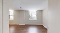 Located at 902 N Market St in downtown Wilmington, Delaware, this 2-bedroom, 1-bathroom residence offers a functional and modern layout across a single floor. Warm hardwood-style flooring flows consistently throughout the living areas and bedrooms, creating a cohesive and inviting atmosphere.

The living room is generously sized, featuring multiple windows that allow natural light to fill the space and offer views of the surrounding urban environment. The open, neutral-toned walls provide a versatile canvas for any décor style.

The kitchen is well-appointed with light shaker-style cabinetry, granite countertops, stainless steel appliances including a full-size refrigerator and dishwasher, and ample storage space — making it both practical and visually appealing.

The primary bedroom is a comfortable retreat, featuring a window with outdoor views and hardwood-style flooring. The second bedroom is similarly finished, maintaining the clean, consistent aesthetic found throughout the home.

The full bathroom is neatly designed with large-format dark tile flooring, a tub/shower combo with a curved rod, a vanity with storage, and clean white walls that contribute to a bright, functional space.

Overall, the residence presents a clean, modern aesthetic with consistent finishes, natural light, and a practical layout well-suited for urban living in downtown Wilmington.