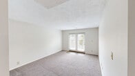 Located at Poplar Level Plaza in Louisville, KY, this one-bedroom, one-bathroom unit offers a well-organized single-floor layout designed for comfortable everyday living. The living room is generously sized, featuring plush wall-to-wall carpeting, a textured ceiling, and a set of French doors that invite natural light and provide access to the outdoors. Adjacent to the living area, the combined dining and kitchen space transitions to wood-look luxury vinyl flooring. The kitchen is well-appointed with white cabinetry, granite-style countertops, and a full suite of stainless steel appliances including a refrigerator, electric range, dishwasher, and built-in microwave, all illuminated by track lighting overhead. The dining area features a pendant light fixture. The bedroom offers a comfortable footprint with carpeting, a window with natural light, and convenient access to two closets via the hallway. The bathroom includes a tub/shower combination with full tile surround, brushed nickel fixtures, and wood-look flooring. A utility room and additional hallway closet provide practical storage. The neutral color palette throughout creates a clean, move-in ready atmosphere.