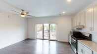Located at 5809 Madison Rd in Cincinnati's 45227 zip code, this single-floor unit offers a clean, modern aesthetic throughout. The open living area is bright and airy, finished with dark hardwood-style flooring and recessed lighting, and is anchored by a ceiling fan. Sliding glass doors lead to a private balcony, filling the space with natural light and providing views of the surrounding neighborhood streetscape.

The kitchen is thoughtfully designed with white shaker-style cabinetry, granite countertops, a classic subway tile backsplash, and a full suite of stainless steel appliances including a gas range, dishwasher, and refrigerator. A walk-in closet or pantry space is conveniently accessible directly from the kitchen area.

The bedroom is a comfortable, well-proportioned room with the same dark hardwood-style flooring, a ceiling fan, and ample wall space. The bathroom is clean and functional, featuring wood-look flooring, a bathtub/shower combination, and a straightforward, minimal design.

Throughout the unit, white walls and consistent flooring create a cohesive, contemporary feel that is both practical and inviting, making this a well-appointed space in the Madison Road corridor of Cincinnati.