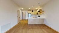 Located at 6706 Old Sauk Rd in Madison, Wisconsin, this well-designed one-bedroom, one-bathroom unit offers a thoughtful layout with modern finishes throughout. Light-toned hardwood-style flooring runs continuously across the entire space, creating a cohesive and inviting atmosphere.

The open-concept kitchen is a standout feature, equipped with stainless steel appliances including a refrigerator, electric range, and over-the-range microwave. Light natural wood cabinetry with sleek hardware pairs with white quartz countertops and a classic subway tile backsplash. A peninsula with pendant lighting adds both style and functionality, making the kitchen an ideal space for cooking and entertaining.

The living area is bright and airy, with access to a private balcony that brings in natural light and outdoor views, enhancing the overall sense of openness.

The bedroom is a calm, well-proportioned retreat featuring a large window that frames lush greenery outside, filling the room with natural light. A dedicated closet provides convenient built-in storage.

The bathroom is finished with a light wood vanity, white countertop, framed mirror, and warm overhead lighting, delivering a clean and functional design.

Overall, this unit combines contemporary design with practical living in a comfortable and efficiently organized space.