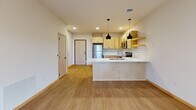 Located at 6706 Old Sauk Rd in Madison, Wisconsin, this well-designed one-bedroom, one-bathroom unit offers a thoughtful layout with modern finishes throughout. Light-toned hardwood-style flooring runs continuously across the entire space, creating a cohesive and inviting atmosphere.

The open-concept kitchen is a standout feature, equipped with stainless steel appliances including a refrigerator, electric range, and over-the-range microwave. Light natural wood cabinetry with sleek hardware pairs with white quartz countertops and a classic subway tile backsplash. A peninsula with pendant lighting adds both style and functionality, making the kitchen an ideal space for cooking and entertaining.

The living area is bright and airy, with access to a private balcony that brings in natural light and outdoor views, enhancing the overall sense of openness.

The bedroom is a calm, well-proportioned retreat featuring a large window that frames lush greenery outside, filling the room with natural light. A dedicated closet provides convenient built-in storage.

The bathroom is finished with a light wood vanity, white countertop, framed mirror, and warm overhead lighting, delivering a clean and functional design.

Overall, this unit combines contemporary design with practical living in a comfortable and efficiently organized space.