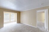 Located at 15530 Ella Blvd in Houston, TX, this single-floor, one-bedroom, one-bathroom unit offers a practical and efficiently designed layout. The entrance opens into a well-organized floor plan that includes a combined kitchen and living room, two closets, a pantry, a bonus room, and a full bathroom.

The open-concept living area is finished with soft, neutral-toned walls and plush carpeting that runs throughout the main spaces, creating a warm and cohesive atmosphere. Large windows allow natural light to filter in, offering pleasant outdoor views of surrounding greenery. Crown molding and textured ceilings add a subtle architectural detail to the living room.

The galley-style kitchen is a functional highlight, featuring white cabinetry, dark granite-style countertops, black appliances including a range and refrigerator, a double stainless steel sink, and rich hardwood flooring — a clean contrast to the carpeted living spaces.

The bedroom is a comfortable, well-proportioned space with carpeted floors, neutral walls, and a large window that brings in natural light. Two closets provide ample storage throughout the unit, along with a dedicated pantry adjacent to the kitchen.

The bathroom is finished in white with a combined tub and shower, complemented by hardwood flooring and clean, simple fixtures. A bonus room adds versatile additional space suitable for a home office or storage.