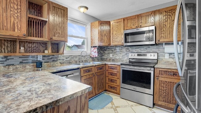 Building Photo - For Rent : 4BR, 1 1/2BA home with fenced in back yard and storage building.