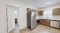 Located at 1023 Old Lascassas Road in Murfreesboro, TN, this single-floor, one-bedroom, one-bathroom unit offers a practical and well-designed layout making smart use of its compact footprint. Light hardwood-style flooring runs throughout the entire space, lending a clean, cohesive look that brightens each room.

The kitchen is a standout feature, equipped with a full suite of stainless steel appliances — including a refrigerator, range, microwave, and dishwasher — paired with warm-toned wood cabinetry that extends to the upper walls for generous storage. A window above the sink allows natural light to fill the space.

The bedroom is the most spacious room in the unit, offering comfortable room for furnishings. Two windows provide natural light and outdoor views, while a ceiling fan enhances airflow and comfort. A dedicated closet adds practical storage.

The bathroom is clean and functional, featuring a tub-shower combo, toilet, and a wood-cabinet vanity topped with a white countertop and large mirror. Consistent light flooring ties it seamlessly to the rest of the unit.

The overall ambiance is bright, clean, and move-in ready, with a neutral color palette and modern finishes throughout that make the space feel fresh and welcoming.