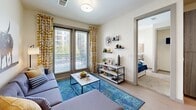 Located at 101 E Abram St in Arlington, TX, this well-appointed 3-bedroom, 3-bathroom unit offers a thoughtfully designed single-floor layout. The modern kitchen is a standout feature, showcasing wood-tone cabinetry, a light blue subway tile backsplash, granite countertops, a central island with bar seating, and a full suite of stainless steel appliances including a refrigerator, range, microwave, and dishwasher. Light wood-style flooring runs throughout the kitchen and living areas, adding warmth and continuity.

The open living room is bright and inviting, benefiting from large sliding glass doors that lead to a private balcony with views of the surrounding cityscape and greenery, filling the space with natural light. Each of the three bedrooms offers carpeted flooring and windows that bring in additional natural light. The primary bedroom is a comfortable retreat with a dedicated closet. All three bathrooms feature clean, white-tiled tub-shower combinations with wood-look flooring and granite vanities.

A dedicated laundry area houses a full-size washer and dryer with overhead shelving for added storage. A hallway connects the rooms efficiently, and two closets provide ample storage throughout. This unit combines functional design with modern finishes in a convenient Arlington location.