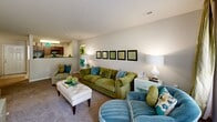 Located at 3668 McConnell Rd in Greensboro, NC, this single-story, 2-bedroom, 2-bathroom residence offers a comfortable and functional layout across a well-utilized floor plan. The living room is bright and welcoming, featuring plush carpet, neutral-toned walls, and a sliding glass door that fills the space with natural light and provides access to an outdoor area. The open sightline into the kitchen keeps the common areas feeling connected and spacious.

The kitchen is outfitted with dark cabinetry, granite-style countertops, a double-basin sink, and black stainless steel appliances including a refrigerator, range, and dishwasher, all set atop clean tile flooring. Adjacent to the kitchen, the dining area accommodates a full-sized dining table and is conveniently located near the in-unit laundry closet, which houses a full-size washer and dryer with overhead wire shelving.

The generously sized primary bedroom features carpet flooring, a ceiling fan, and a large window with access to the adjoining bathroom. The en-suite bathroom includes a single vanity with dark wood cabinetry and a tub-shower combination. The second bedroom is well-proportioned with ample closet access. Both bathrooms are finished with tile flooring and tub-shower units. A dedicated hallway and closet add to the overall practicality of this thoughtfully designed residence.