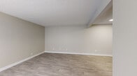 Located on N Pantano Rd in Tucson, AZ, this single-floor unit offers three bedrooms, one bathroom, a living room, kitchen, and hallway within a compact yet efficiently arranged floor plan. Light gray vinyl plank flooring runs consistently throughout the space, complementing neutral beige walls and white baseboards to create a clean, cohesive aesthetic.

The living room serves as the central hub of the unit, featuring a textured ceiling, a window allowing natural light to filter in, and direct sightlines to the kitchen. The galley-style kitchen is well-appointed with white shaker cabinetry, light countertops, and a full suite of stainless steel appliances, including a refrigerator, electric range, microwave, and dishwasher.

The three bedrooms maintain consistent finishes with textured ceilings and vinyl plank flooring. Several bedrooms feature windows that bring in natural light, and the primary bedroom includes access to the shared bathroom. The bathroom is cleanly finished with a white tub-shower combination, a vanity with a white countertop, and matching light flooring, maintaining the unit's uniform, move-in-ready presentation.