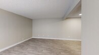 Located on N Pantano Rd in Tucson, AZ, this single-floor unit offers three bedrooms, one bathroom, a living room, kitchen, and hallway within a compact yet efficiently arranged floor plan. Light gray vinyl plank flooring runs consistently throughout the space, complementing neutral beige walls and white baseboards to create a clean, cohesive aesthetic.

The living room serves as the central hub of the unit, featuring a textured ceiling, a window allowing natural light to filter in, and direct sightlines to the kitchen. The galley-style kitchen is well-appointed with white shaker cabinetry, light countertops, and a full suite of stainless steel appliances, including a refrigerator, electric range, microwave, and dishwasher.

The three bedrooms maintain consistent finishes with textured ceilings and vinyl plank flooring. Several bedrooms feature windows that bring in natural light, and the primary bedroom includes access to the shared bathroom. The bathroom is cleanly finished with a white tub-shower combination, a vanity with a white countertop, and matching light flooring, maintaining the unit's uniform, move-in-ready presentation.