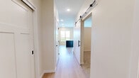 Located at 6701 W 78th St in Bloomington, MN, this one-bedroom, one-bathroom unit offers a thoughtfully designed layout that maximizes every square foot of its compact footprint. The open kitchen is a standout feature, boasting warm wood cabinetry, light-toned countertops, a tiled backsplash, and a full suite of stainless steel appliances including a refrigerator, electric range, built-in microwave, and dishwasher. A kitchen island provides additional prep and storage space, while a large window frames a scenic, tree-lined outdoor view and fills the space with natural light. Light hardwood-style flooring flows throughout the main living and kitchen areas, lending a clean, contemporary feel. The bedroom offers a comfortable, carpeted retreat with neutral walls and a set of sliding panel closet doors featuring a classic craftsman-style design, providing practical storage. The bathroom is outfitted with a full soaking tub and shower combination accented by matte black fixtures, maintaining the unit's modern aesthetic. The overall ambiance is bright, clean, and functional, making this an ideal space for those seeking a well-appointed home in a convenient Bloomington location.