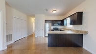 Located at 133 Holland Dr in Clarksville, Tennessee, this single-story, 3-bedroom, 2-bathroom home offers a well-designed layout with a clean, neutral aesthetic throughout. The polished concrete floors are a standout architectural feature, extending through the main living areas and bedrooms, providing a sleek, low-maintenance surface that reflects natural light beautifully.

The kitchen is thoughtfully appointed with rich, dark espresso cabinetry, granite countertops, stainless steel appliances including a refrigerator, range, and built-in microwave, and a peninsula that provides additional prep and seating space. A window above the sink allows natural light to fill the space.

Each of the three bedrooms features ceiling fans with light fixtures and windows that invite natural light. The generously sized primary bedroom offers ample room for furnishings. The two secondary bedrooms provide comfortable, versatile spaces suitable for various uses.

The bathrooms are well-finished, featuring dark vanity cabinetry topped with granite countertops and a full tub-shower combination with clean white surrounds. Three closets provide practical storage distributed across the home.

A connecting hallway ties the layout together efficiently, and the overall design maintains a consistent, neutral color palette that creates a bright, open ambiance throughout the home.
