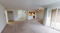 Located at 480 Eagle Dr in Elk Grove Village, Illinois, this single-floor unit offers a practical and well-appointed layout designed for comfortable everyday living. The expansive open-concept living and dining area is finished with plush wall-to-wall carpeting and features a ceiling fan overhead. A sliding glass door floods the space with natural light and provides access to an outdoor area, while vertical blinds offer adjustable privacy. The kitchen is a standout feature, showcasing rich dark-wood cabinetry extending to the ceiling, granite-toned countertops, tile flooring, and a full suite of stainless steel appliances including a gas range, built-in microwave, refrigerator, and dishwasher. A double-basin sink and under-cabinet lighting complete the functional workspace. The bedrooms are generously sized, carpeted, and include closet access, with one bedroom offering a connection to an additional room or walk-in closet area. The bathroom is well-finished with tile flooring, a wood-toned vanity, a large mirror with overhead lighting, and a tiled tub-and-shower combination. The overall layout is cohesive and move-in ready, offering a clean, neutral palette throughout.