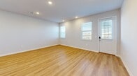 Located in Palmetto, FL, this two-story home offers four bedrooms and three bathrooms spread across two well-proportioned floors. The main level features an open-concept kitchen and living area anchored by a large center island with a crisp white quartz countertop, undermount sink, and stainless steel appliances, including a range, microwave, and refrigerator. Soft gray shaker-style cabinetry and recessed lighting complete the modern aesthetic. Light-toned wood-look flooring runs throughout, adding warmth and cohesion to the space.

The upper floor houses the generously sized primary bedroom alongside additional bedrooms, each brightened by natural light through slatted-blind windows and finished with the same wood-look flooring. Closets are outfitted with wire shelving systems for practical organization. A dedicated upstairs laundry room accommodates a full-size washer and dryer. The three bathrooms maintain the home's clean, neutral palette.

The attached garage features concrete block construction, an automatic opener, and houses the water heater and electrical panel. Outside, a private gated backyard opens to serene waterfront views, bordered by a black iron fence — a standout feature offering a peaceful outdoor retreat in this Florida community.
