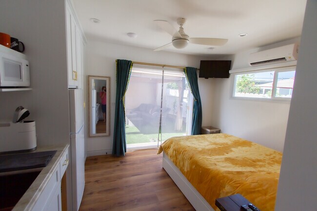 The bed looks out through French doors that overlook the outdoor living & dining area. - 2150 Euclid Ave