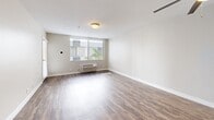 Located at 600 Front Street in San Diego's vibrant downtown, this one-bedroom, one-bathroom residence offers a thoughtfully designed single-level layout with a comfortable sense of space throughout. Wood-style flooring runs continuously across the living areas, bedroom, and bathroom, lending a cohesive and modern aesthetic to the home.

The open-concept kitchen and living room form the heart of the residence. The kitchen features a peninsula with a light stone-style countertop, white cabinetry with ample storage, a stainless steel refrigerator, and built-in appliances including a range and over-the-range microwave. The peninsula provides a natural division between the kitchen and the living area while keeping the space open and connected.

The living room is bright and airy, with a large window fitted with vertical blinds that allows natural light to fill the room. A wall-mounted climate control unit ensures year-round comfort.

The bedroom is a well-proportioned private retreat, featuring wood-style flooring, neutral warm-toned walls, and a window that brings in additional natural light.

The bathroom is clean and functional, with white cabinetry including an over-toilet storage cabinet, a vanity with mirror, and wood-style flooring that ties the space together. Neutral walls and white trim throughout the home create a bright, move-in-ready atmosphere ideal for downtown San Diego living.