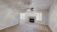 Located at 500 Harbor Pointe Pkwy in Sandy Springs, GA, this one-bedroom, one-bathroom residence offers a well-organized single-floor layout with a comfortable and functional living environment. The spacious living room serves as the heart of the home, showcasing vaulted ceilings, a ceiling fan with light fixture, plush carpeting, and a tile-surround fireplace as a central focal point. Multiple windows with blinds allow natural light to fill the room, creating a bright and airy atmosphere. The entrance opens directly into this generous living area, which also provides access to the kitchen via a pass-through opening. The kitchen features white cabinetry, dark granite-style countertops, a stainless steel refrigerator, and a gas range, offering an efficient and stylish cooking space. The bedroom is a well-proportioned, carpeted retreat with neutral tones and ample wall space, accompanied by a dedicated closet for storage. The bathroom is finished with wood-look flooring, white cabinetry with granite-style counters, and a full tub and shower combination with tiled surround. Hallways connect the rooms seamlessly, contributing to the overall ease of flow throughout this neatly designed residence.