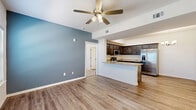 Located at 17900 N May Ave in Oklahoma City, OK, this single-story, 3-bedroom, 2-bathroom home offers a well-designed layout with a cohesive mix of modern finishes and functional spaces. The open-concept living and kitchen area serves as the heart of the home, featuring wood-look plank flooring, a ceiling fan with light, and a large window that invites natural light. A bold accent wall in the living area adds a distinctive touch of color.

The kitchen is well-appointed with rich, dark wood cabinetry, granite-look countertops, a peninsula with a double sink, and a full suite of stainless steel appliances including a range, microwave, and French door refrigerator. A chandelier overhead adds a refined accent to the cooking space.

The three bedrooms are carpeted and bright, each featuring windows with blinds that bring in natural light. The primary bedroom includes its own closet, while additional closets throughout provide ample storage. One bathroom features a tub-shower combination with tile surround, a granite-top vanity with dark wood cabinetry, and wood-look flooring. The second bathroom conveniently doubles as a laundry space. Three dedicated closets round out the storage options throughout this well-planned home.
